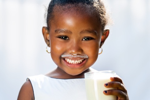 young girl drinking milk.