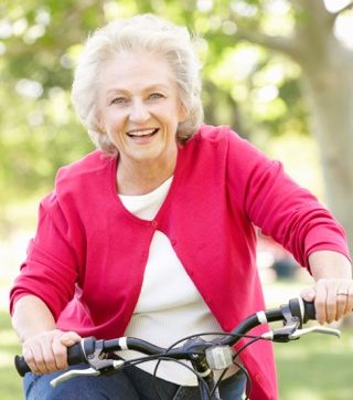 elderly woman riding a bicycle.