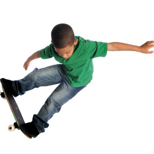 Child doing a trick on a skateboard.