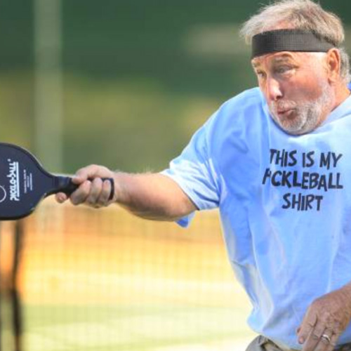 A man playing pickelball.