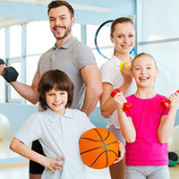 Family photo of people with multiple sports equipment.