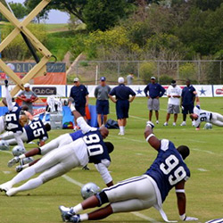 Photo of football players warming up before a game.