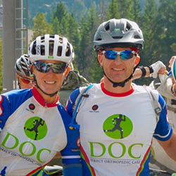 Two DOC practitioners in biking helmets.