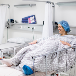 Woman in a hospital bed.