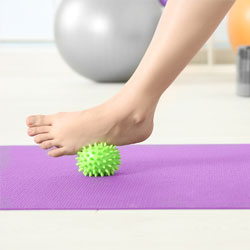 Photo of woman's foot stretching on a medicine ball.