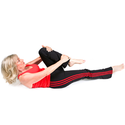 woman doing a stretch to relieve back pain.