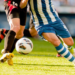 athletes playing soccer.