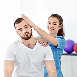 Woman stretching man's neck.