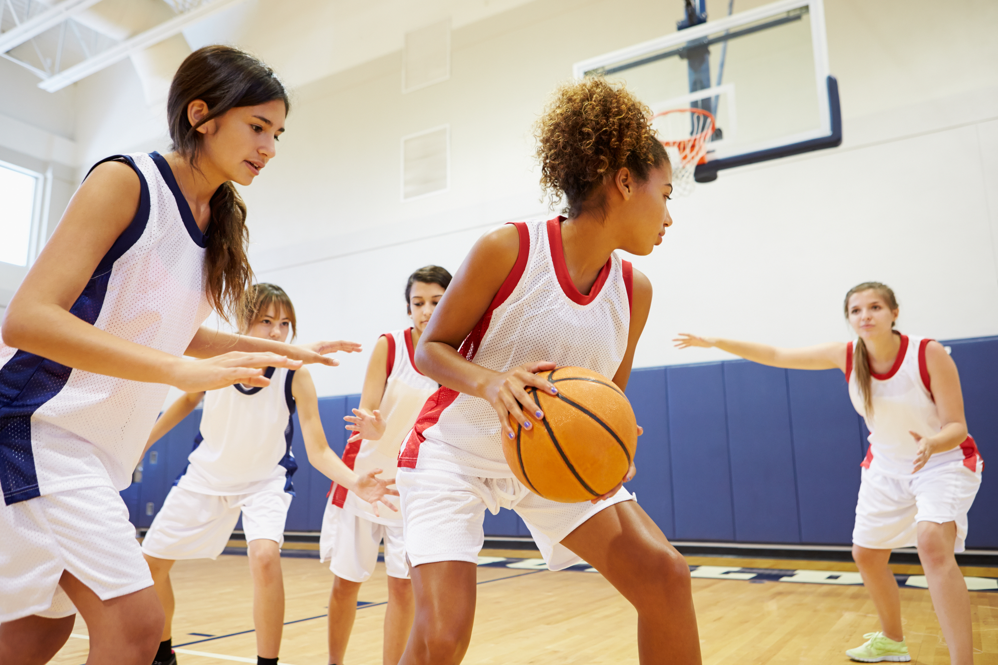 Female High School Basketball Team Playing Game.