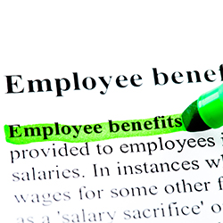 The words "employee benefits" being highlighted on a sheet of paper.