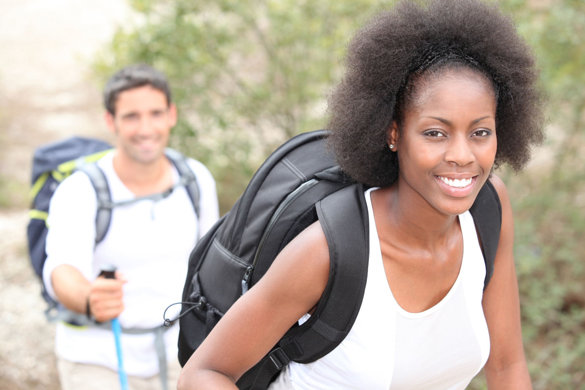 Woman hiking and smiling.