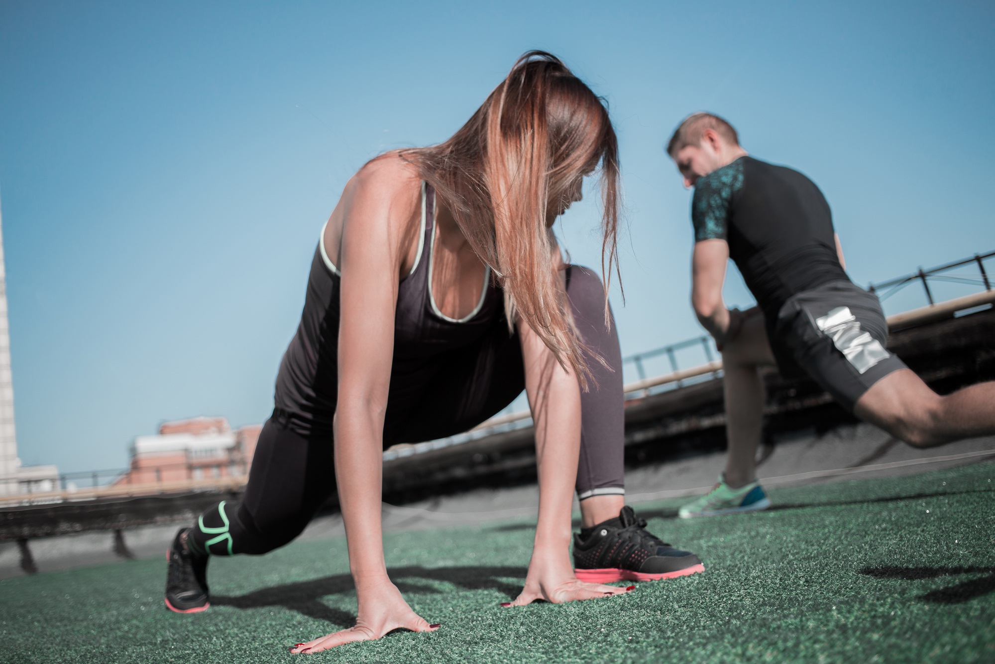 Female runner stretching outdoors.