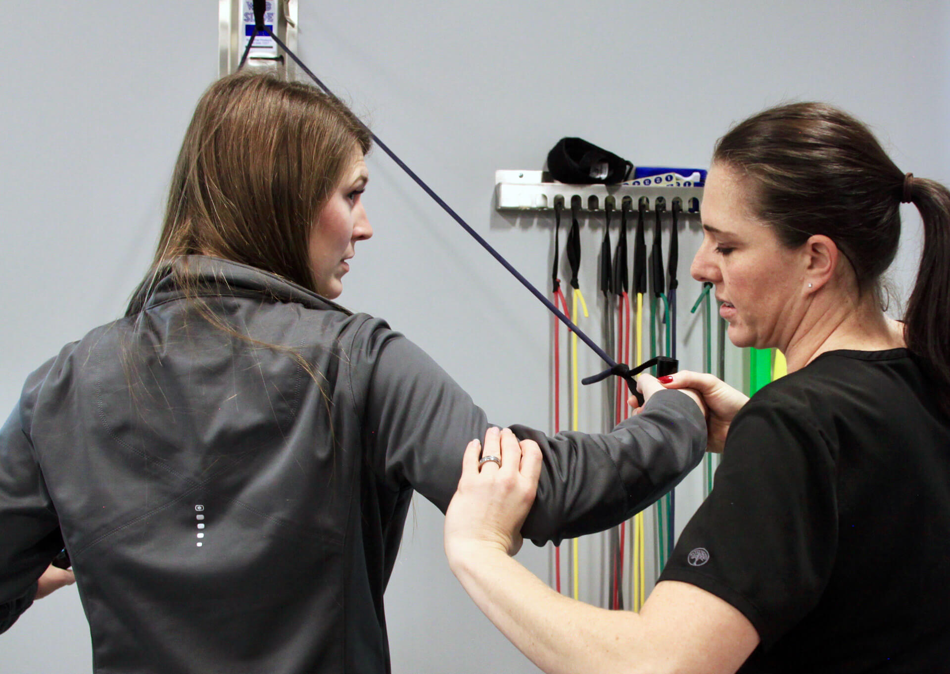 Physical therapist works through conventional therapy exercises with patient.