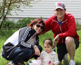 Amanda outside with young girl and man.