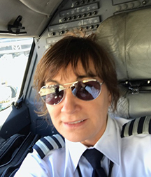 Selfie of Karen in the cockpit of a plane.