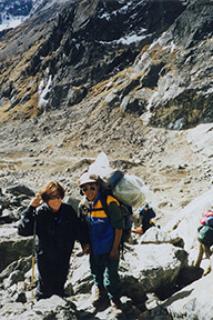 Nancy and her partner hiking in a rocky area.