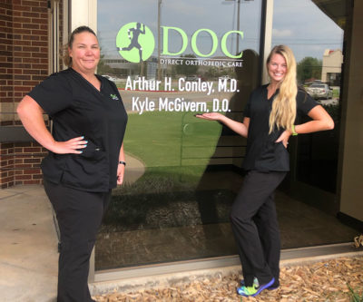 Two DOC team members stand outside of the Oklahoma City clinic location.