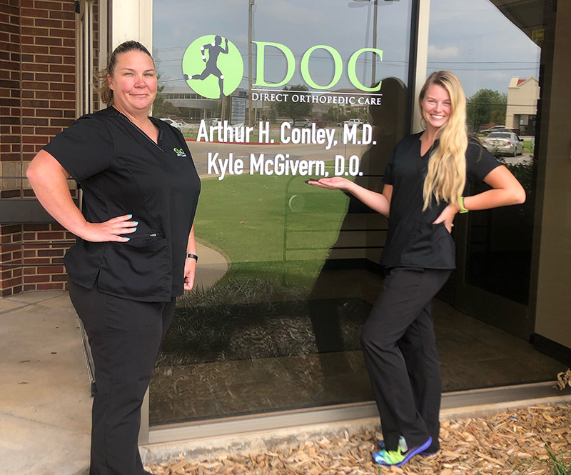 Two DOC team members stand outside of the Oklahoma City clinic location.