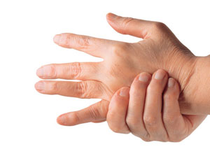 Person grabbing hand from rheumatoid arthritis pain.