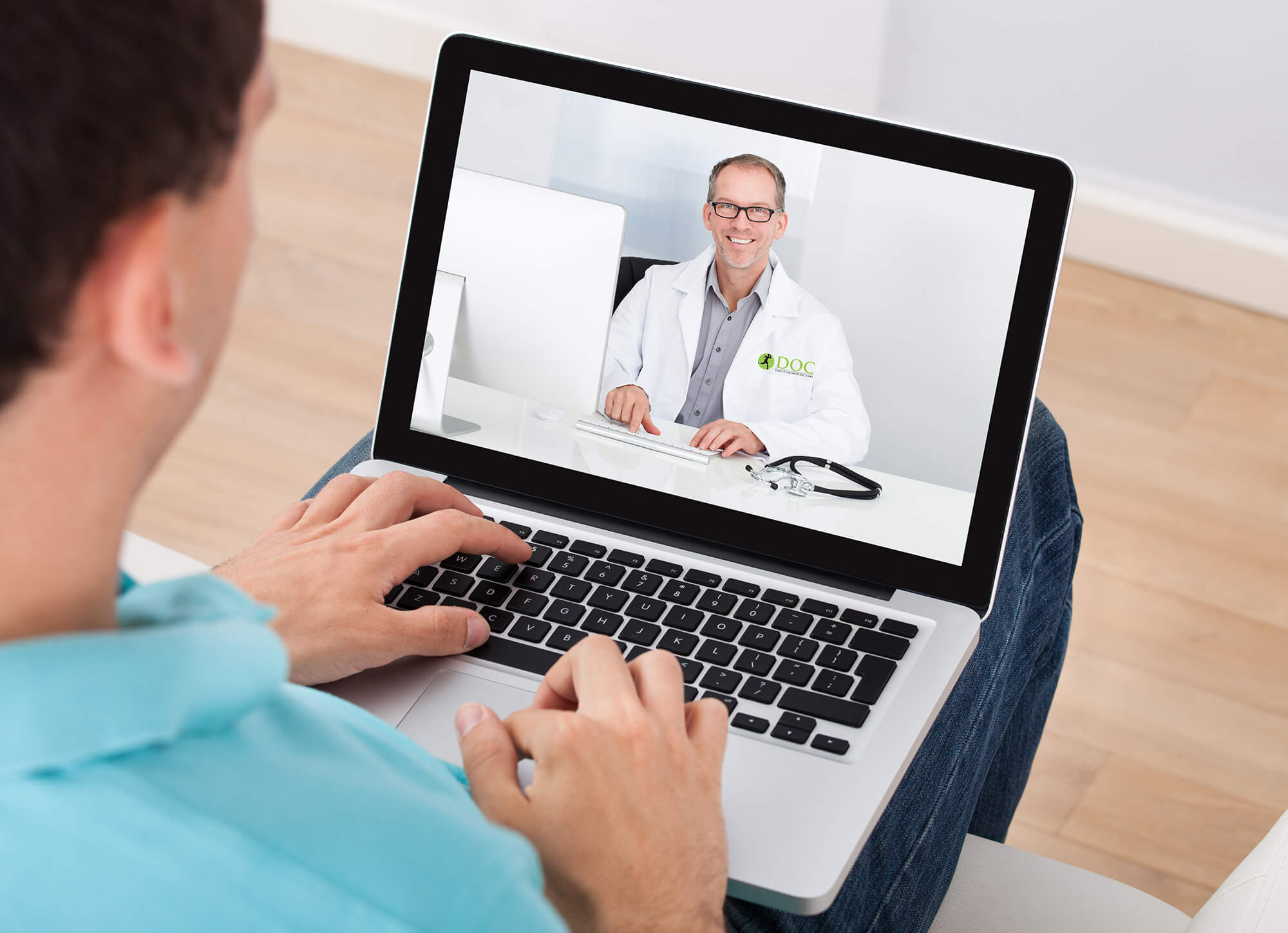 Patient speaking with DOC provider virtually through laptop.