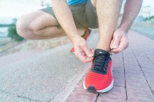 man tying shoes